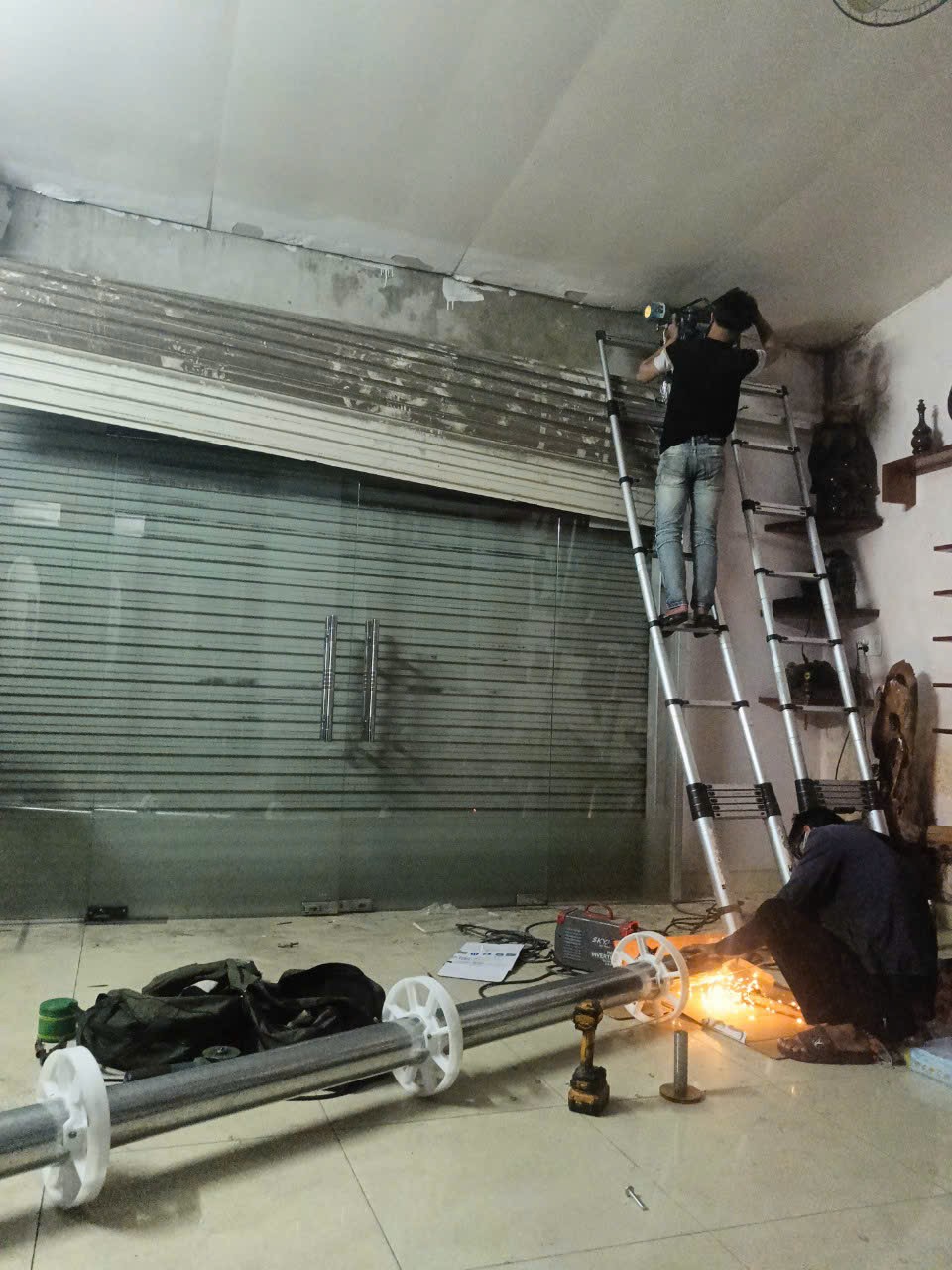 Kỹ thuật viên FIX365 trực tiếp kiểm tra và sửa cửa cuốn tại nhà khách hàng Quận 9, xác định đúng nguyên nhân hư hỏng và xử lý an toàn.