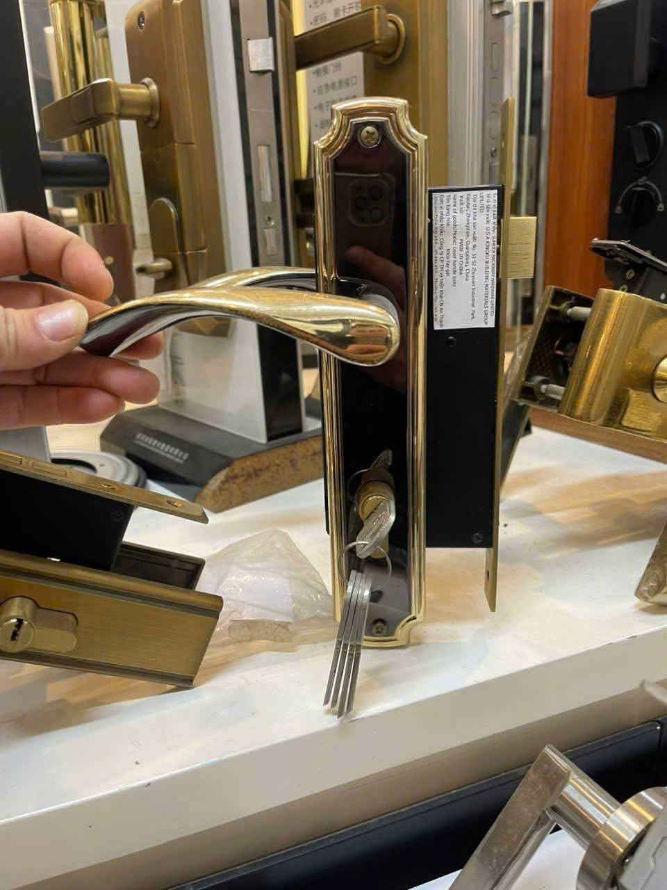 Bộ khóa cửa tay gạt màu vàng đồng cao cấp kèm chìa khóa trưng bày tại cửa hàng